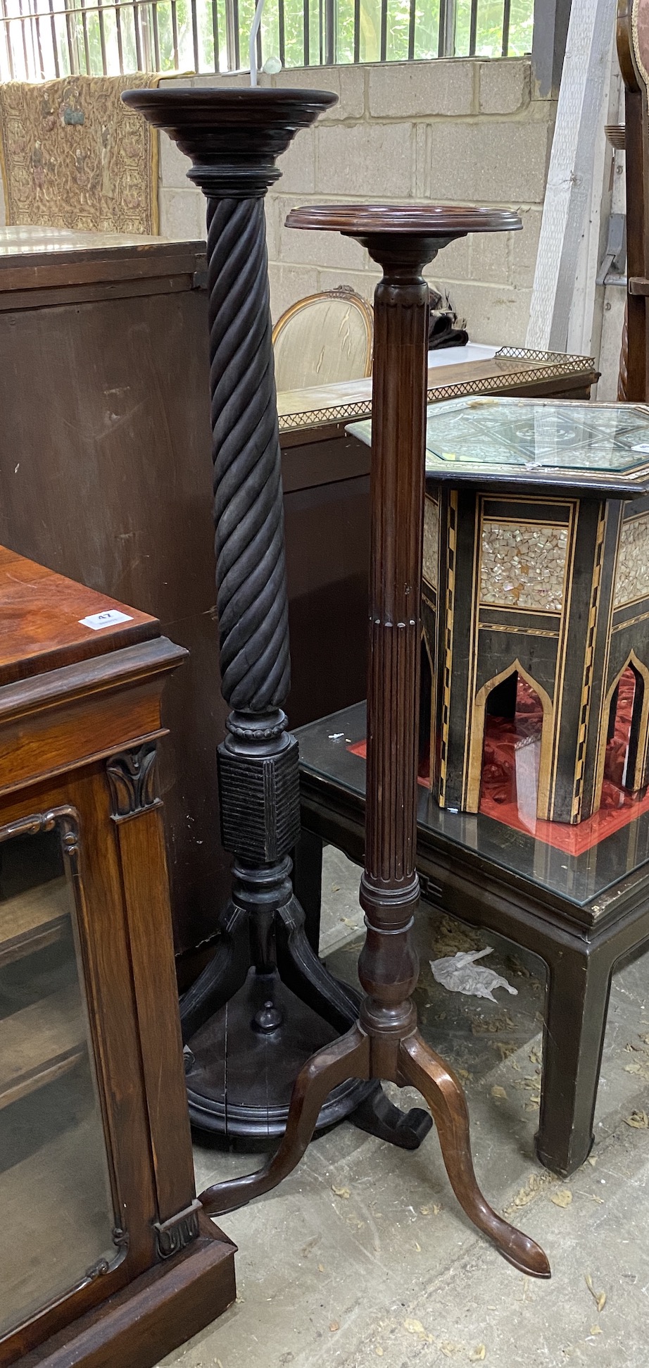 Two 19th century and later mahogany torcheres, tallest 138cm high